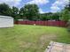 A large backyard, enclosed by a fence, featuring a storage shed at 60 King Blvd, Mcdonough, GA 30253