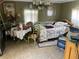An untidy but cozy bedroom with a tiled floor, a bed and a dining table at 60 King Blvd, Mcdonough, GA 30253