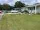 A charming home with a green lawn, bordered flower beds, and a cozy covered porch at 60 King Blvd, Mcdonough, GA 30253