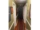 Narrow hallway with a long area rug, olive green walls, and multiple framed pictures at 60 King Blvd, Mcdonough, GA 30253