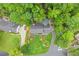 Expansive lawn with mature trees surrounds the traditional home with an asphalt driveway and detached garage at 1540 Kinglet Ln, Marietta, GA 30062