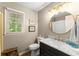 Bathroom with marble countertop, round mirror, and walk-in shower at 1540 Kinglet Ln, Marietta, GA 30062