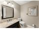 Bathroom featuring a granite vanity, decorative mirror, and tile flooring at 1540 Kinglet Ln, Marietta, GA 30062