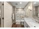 Well-lit bathroom with a glass shower, marble vanity, and a door that provides privacy at 1540 Kinglet Ln, Marietta, GA 30062