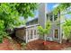 Back exterior view of home boasting a sunroom, gray siding, and lush landscaping for serene living at 1540 Kinglet Ln, Marietta, GA 30062
