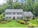 Beautiful two-story home featuring lush landscaping and a manicured lawn at 1540 Kinglet Ln, Marietta, GA 30062