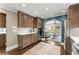 Open kitchen features a stainless fridge, wood cabinets, and views into the living room at 1540 Kinglet Ln, Marietta, GA 30062