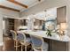 Kitchen featuring wood cabinets, counter seating, modern appliances, and backyard views at 1540 Kinglet Ln, Marietta, GA 30062