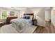 Comfortable main bedroom featuring wood floors, dresser, and two windows allowing ample light at 1540 Kinglet Ln, Marietta, GA 30062
