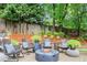 Inviting backyard patio with fire pit, outdoor seating, and lush landscaping offers a perfect spot for relaxation at 1540 Kinglet Ln, Marietta, GA 30062