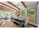 Sun-filled room with wood-beamed ceilings and large windows open to a dining area at 1540 Kinglet Ln, Marietta, GA 30062