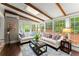 Bright sunroom featuring exposed wood beams, large windows, and a stylish seating area at 1540 Kinglet Ln, Marietta, GA 30062