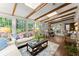 Spacious sunroom with beamed ceilings, large windows, and a cozy seating area at 1540 Kinglet Ln, Marietta, GA 30062