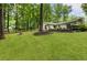 Expansive backyard featuring a well-maintained lawn, a wooden deck, and a tranquil wooded backdrop at 171 North Trce, Alpharetta, GA 30009