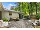 Backyard deck with seating, grill, surrounded by beautiful trees and landscaping at 171 North Trce, Alpharetta, GA 30009