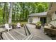 Relaxing outdoor deck area with seating, surrounded by lush greenery, ideal for entertaining at 171 North Trce, Alpharetta, GA 30009