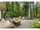 Outdoor deck space with plenty of seating, overlooks the lush backyard and mature landscaping at 171 North Trce, Alpharetta, GA 30009