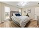 Well-lit bedroom featuring hardwood floors, large window, and ample closet space at 171 North Trce, Alpharetta, GA 30009