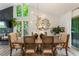 Charming dining room featuring a stone fireplace, statement mirror, and a seamless transition to the living room at 171 North Trce, Alpharetta, GA 30009