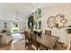 Elegant dining area featuring a rustic wood table, statement mirror, and a seamless transition to the living room at 171 North Trce, Alpharetta, GA 30009