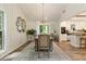 Dining room features natural light, modern lighting, and leads to the kitchen, ideal for gatherings at 171 North Trce, Alpharetta, GA 30009