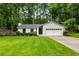 Charming single-story home featuring a lush green lawn, manicured landscaping, and an attached two-car garage at 171 North Trce, Alpharetta, GA 30009