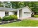 Inviting home exterior with a well-kept lawn, vibrant landscaping, and a classic American flag display at 171 North Trce, Alpharetta, GA 30009