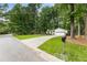 Well-maintained home with a spacious front yard, long driveway, and lush green trees at 171 North Trce, Alpharetta, GA 30009