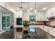 Granite countertops shine in this kitchen with stainless steel appliances and views to the backyard at 171 North Trce, Alpharetta, GA 30009