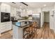 Modern kitchen with stainless steel appliances, granite countertops, island seating, and ample cabinet space at 171 North Trce, Alpharetta, GA 30009