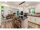 Updated kitchen and dining area with white cabinets, granite counters, and wood flooring at 171 North Trce, Alpharetta, GA 30009