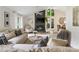 Comfortable living room featuring a stone fireplace, vaulted ceilings, large windows, and stylish décor at 171 North Trce, Alpharetta, GA 30009