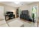Spacious living room with modern decor, ample seating, and an entertainment center with a large TV at 171 North Trce, Alpharetta, GA 30009
