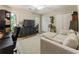 Inviting living room with a large sofa, entertainment center, and natural light from nearby windows at 171 North Trce, Alpharetta, GA 30009