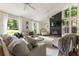 Inviting living room boasts a stone fireplace, large windows, and cozy seating for relaxing and entertaining at 171 North Trce, Alpharetta, GA 30009