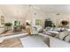 Open-concept living room flows to the dining area with vaulted ceilings, fireplace, and stylish furnishings at 171 North Trce, Alpharetta, GA 30009