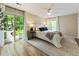 Cozy main bedroom with wood floors, a ceiling fan, and sliding glass door to outdoor patio at 171 North Trce, Alpharetta, GA 30009