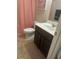 Functional bathroom with a vanity, toilet, shower with patterned curtain, and neutral flooring at 1749 Misselthrush Ln, Mcdonough, GA 30253