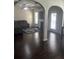Cozy living room featuring dark wood floors, a comfortable sofa, and natural light from windows at 1749 Misselthrush Ln, Mcdonough, GA 30253