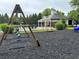 Swing set in playground with picnic benches and a covered pavilion, perfect for community gatherings and relaxation at 1749 Misselthrush Ln, Mcdonough, GA 30253