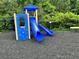 Fun playground featuring a blue slide and climbing area, ideal for outdoor activities and recreation at 1749 Misselthrush Ln, Mcdonough, GA 30253