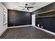 Bedroom with dark walls, floating shelves, large window, and modern ceiling fan at 2153 Cooper Lake Se Rd, Smyrna, GA 30080
