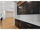 Butler pantry with dark cabinets, quartz countertops, and bar seating at 2153 Cooper Lake Se Rd, Smyrna, GA 30080