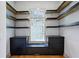 Walk-in closet featuring custom shelves, drawers, and hardwood flooring at 2153 Cooper Lake Se Rd, Smyrna, GA 30080