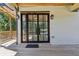 Stylish patio doors lead from the wooden deck into this charming home, complete with lantern sconces and an inviting entrance at 2153 Cooper Lake Se Rd, Smyrna, GA 30080