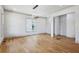 Open room featuring hardwood floors, neutral paint, and modern lighting at 2153 Cooper Lake Se Rd, Smyrna, GA 30080
