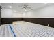 Large open room featuring under-installation flooring and modern ceiling fan at 2153 Cooper Lake Se Rd, Smyrna, GA 30080