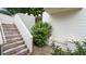 Exterior stairs leading to the home, complemented by a small garden area on the side of the house at 350 Anders N, Chattahoochee Hills, GA 30268