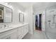Modern bathroom with double vanity, glass-enclosed shower, and walk-in closet access at 1858 Preserve Way, Atlanta, GA 30341