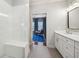 Contemporary bathroom featuring a glass shower, white vanity, and view into the bedroom at 1858 Preserve Way, Atlanta, GA 30341